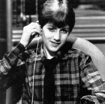 Ryan White at age 14 adjusting an earphone for simultaneous translation during a live interview in Rome.